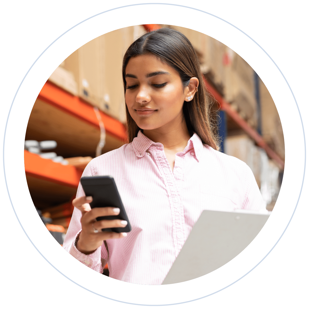 woman looking at phone in stock room